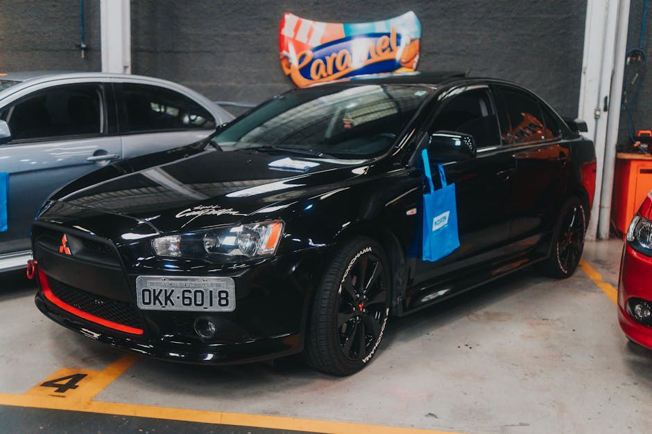 Black Mitsubishi Lancer parked in an indoor garage. Ideal for car enthusiasts and automotive collections.