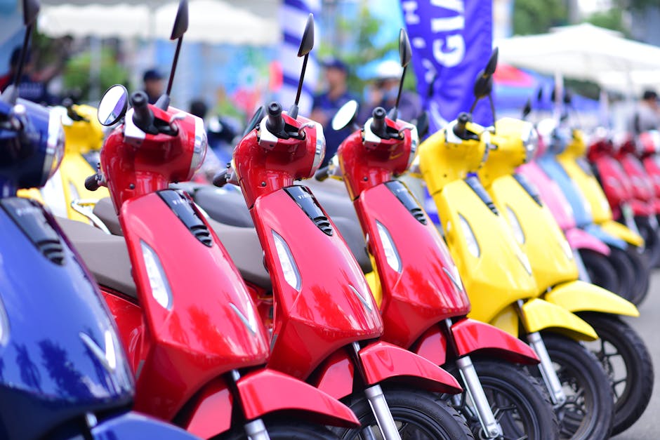 A dynamic line of vibrant scooters showcasing in various colors, parked outdoors.