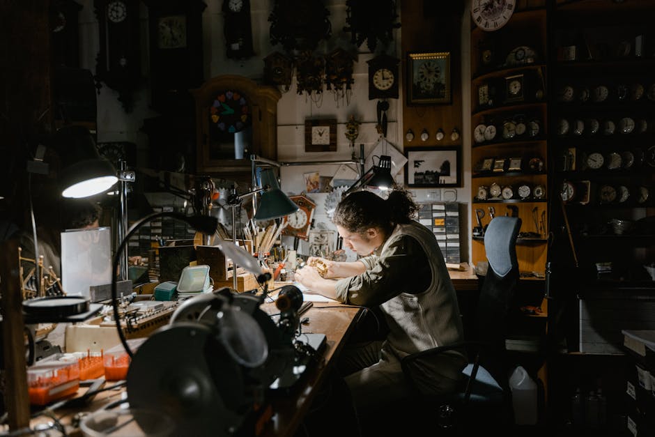 A skilled watchmaker focuses on repairing watches in a meticulously organized workshop.
